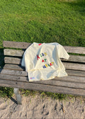 White bag with colorful letters on a wooden bench outdoors

Boxy tshirt, oversized tshirt, drop shoulder, organic cotton, cotton, heavy weight tshirt, breathable tshirt, streetwear tshirt, streetwear, street fashion, drmers club, screen print, screen printing, vancouver brand, clothing brand, high street fashion
